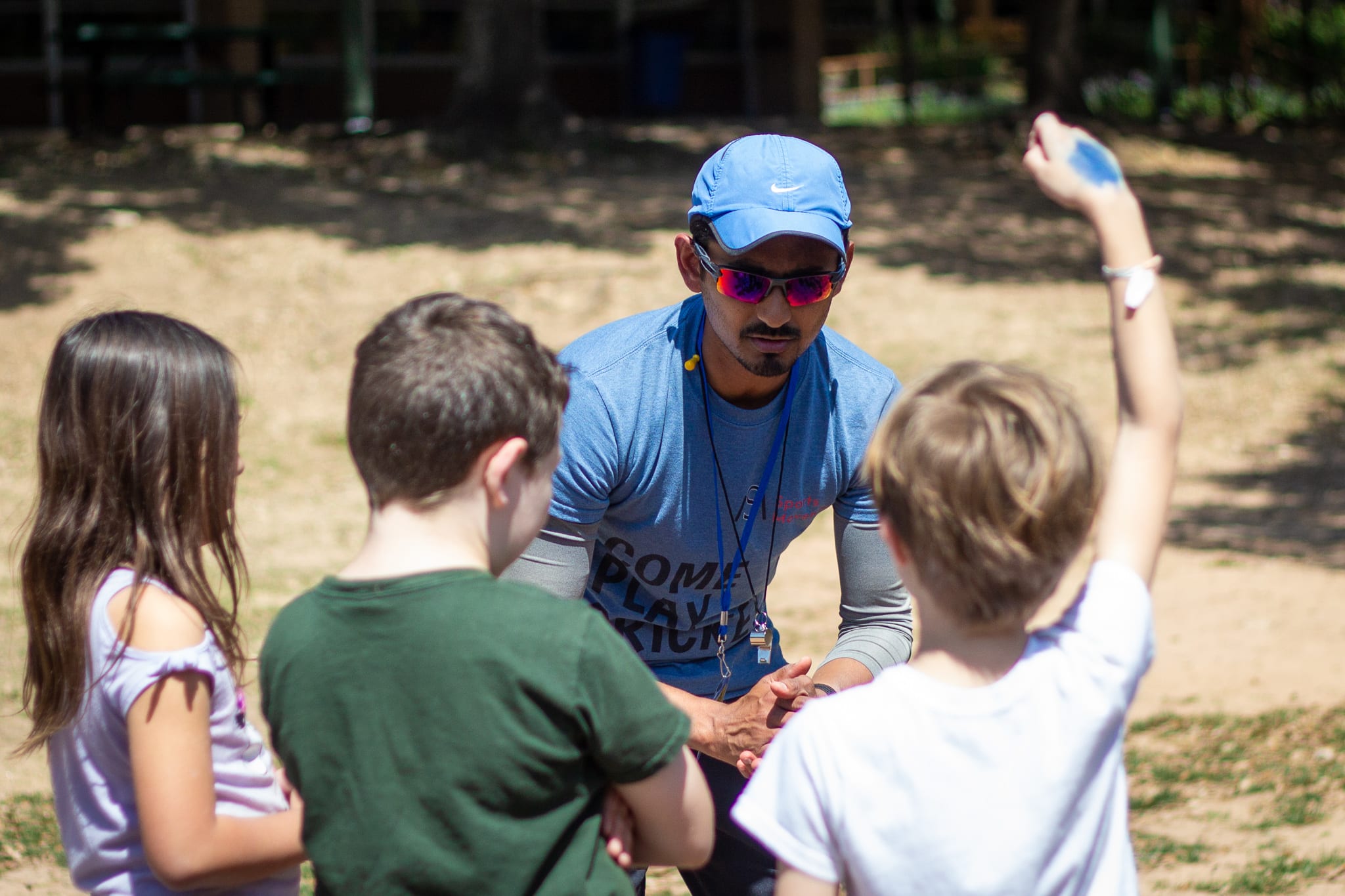 coach talking to three students