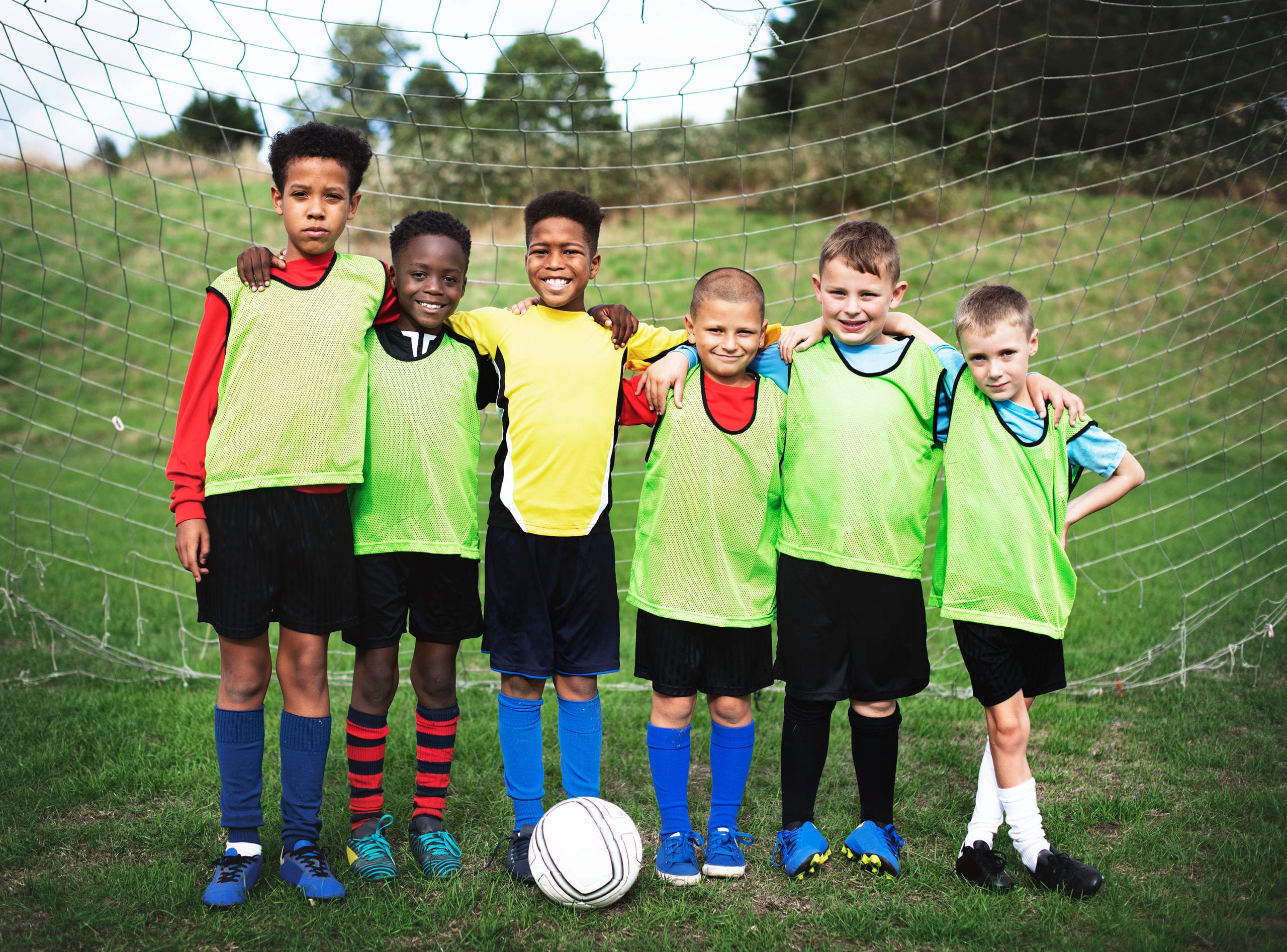 6 Kids In Green Jerseys Playing Soccer 