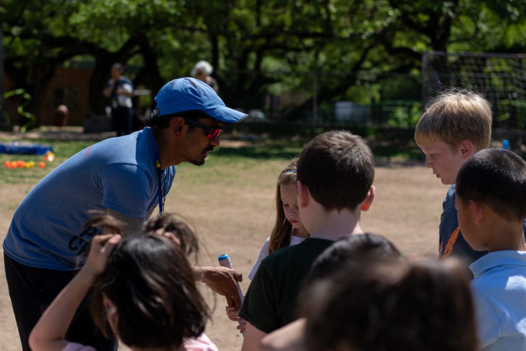 coach explaining cricket to students