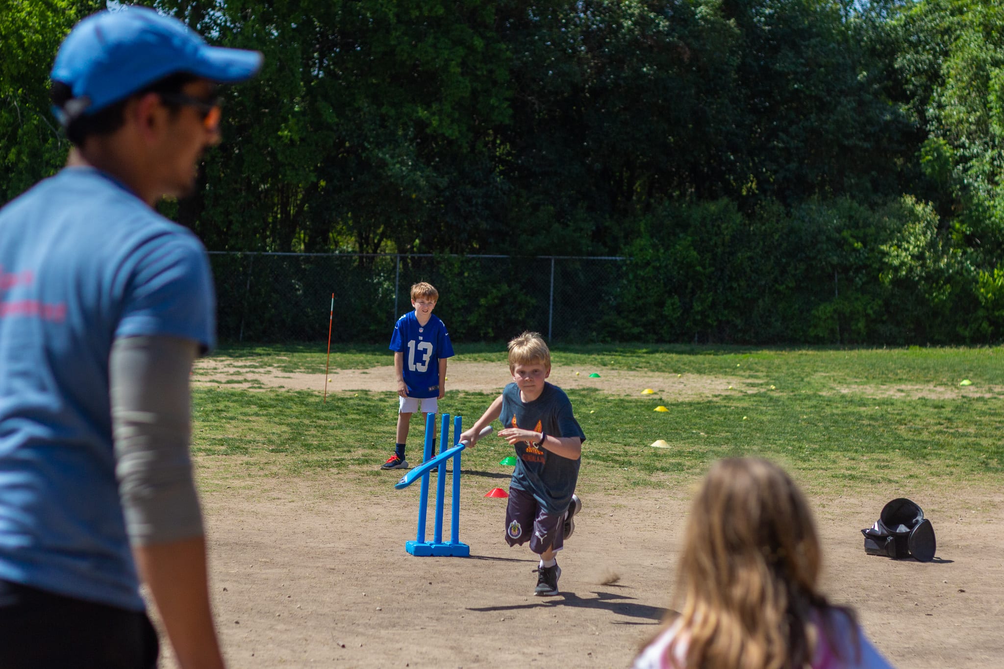 boy running to cricket wicket