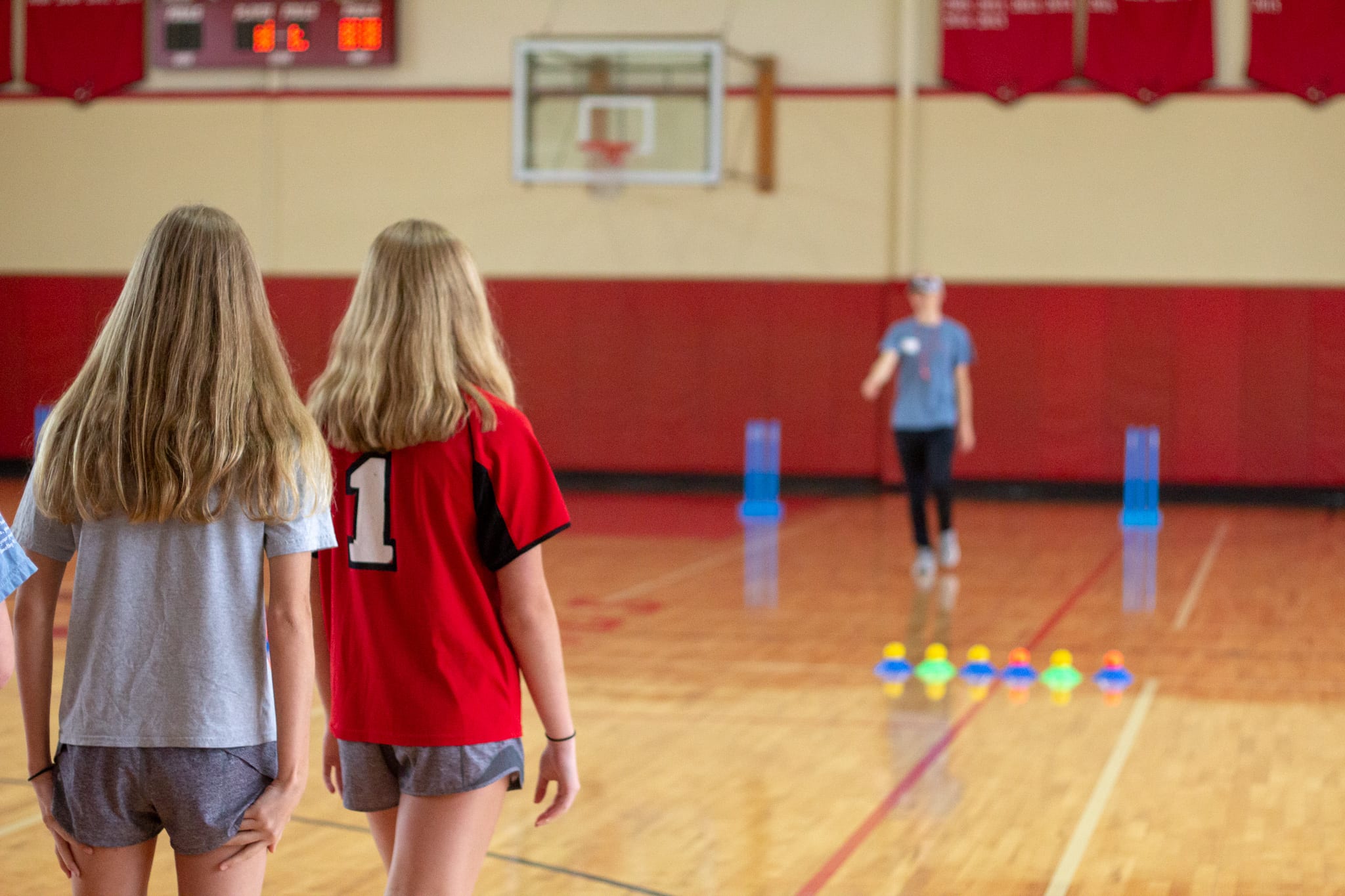 two girls looking at sports movement coach