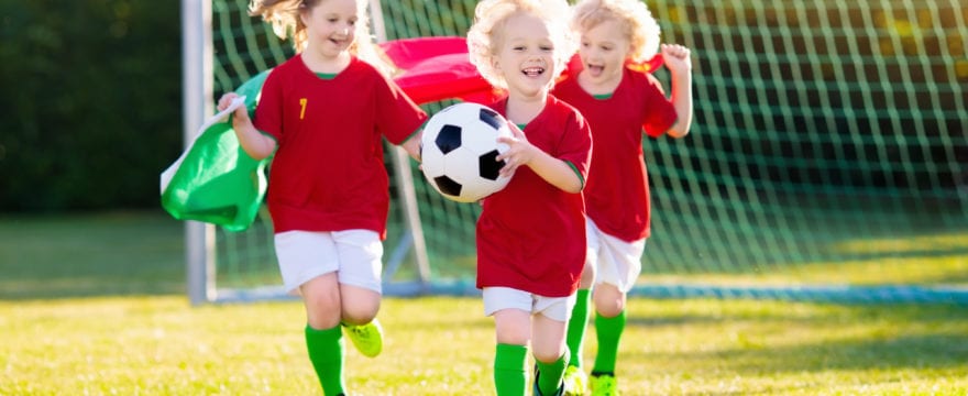 Portugal football fan kids. Children play soccer.