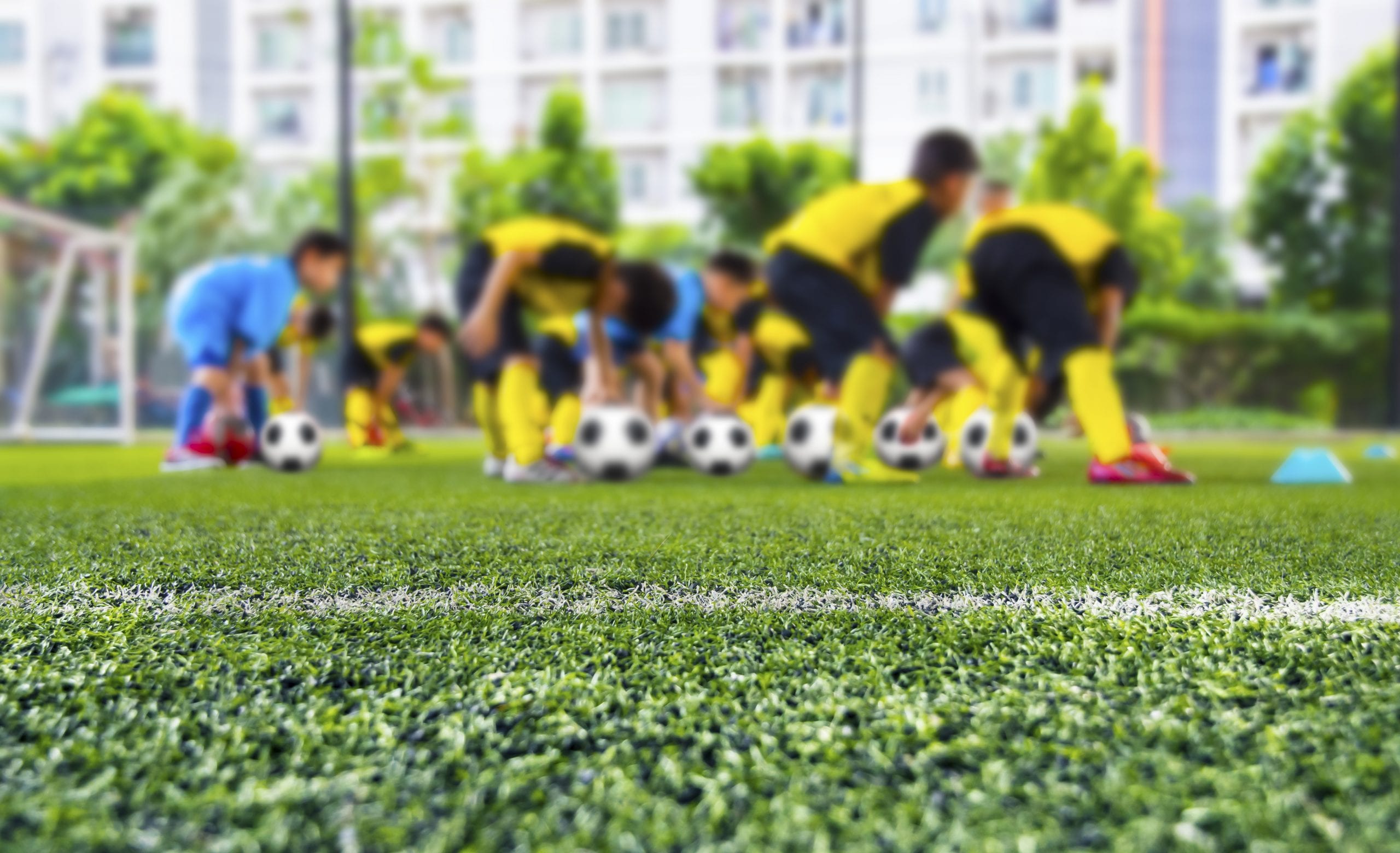 Youth soccer practice drills with cones. Soccer drills: slalom d Youth soccer practice drills with cones. Soccer drills: slalom drill. Young football players training on pitch